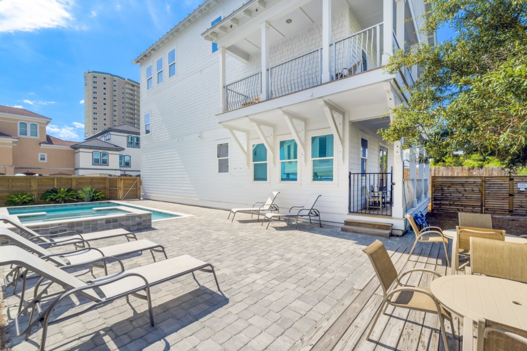 Dining Area And Lounge Chairs By The Pool