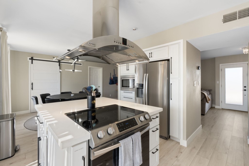 Modern kitchen with stainless steel appliances and a spacious island for meal prep.