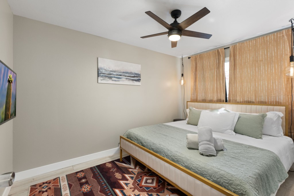 Cozy bedroom with a king-size bed, stylish decor, and soft lighting for a restful stay.