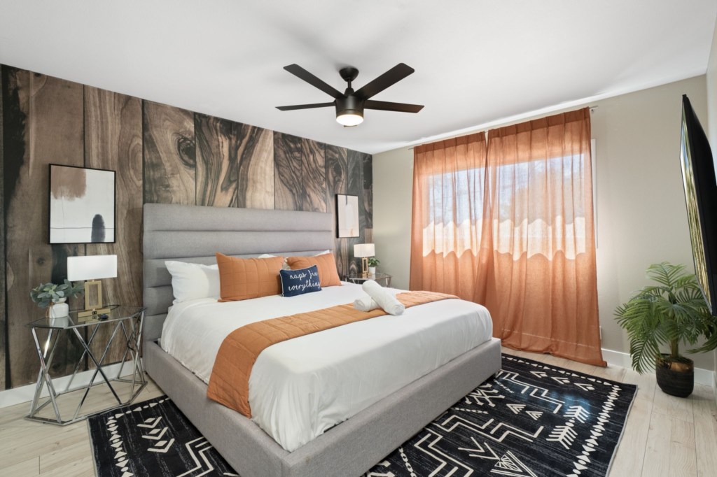 Stylish bedroom with wood accent wall and cozy bedding for a restful stay.