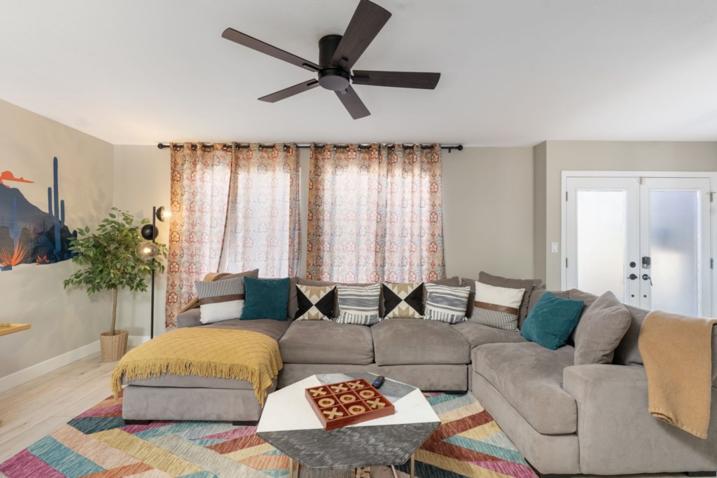 Cozy living room with a plush sectional and colorful decor, perfect for relaxing or entertaining.