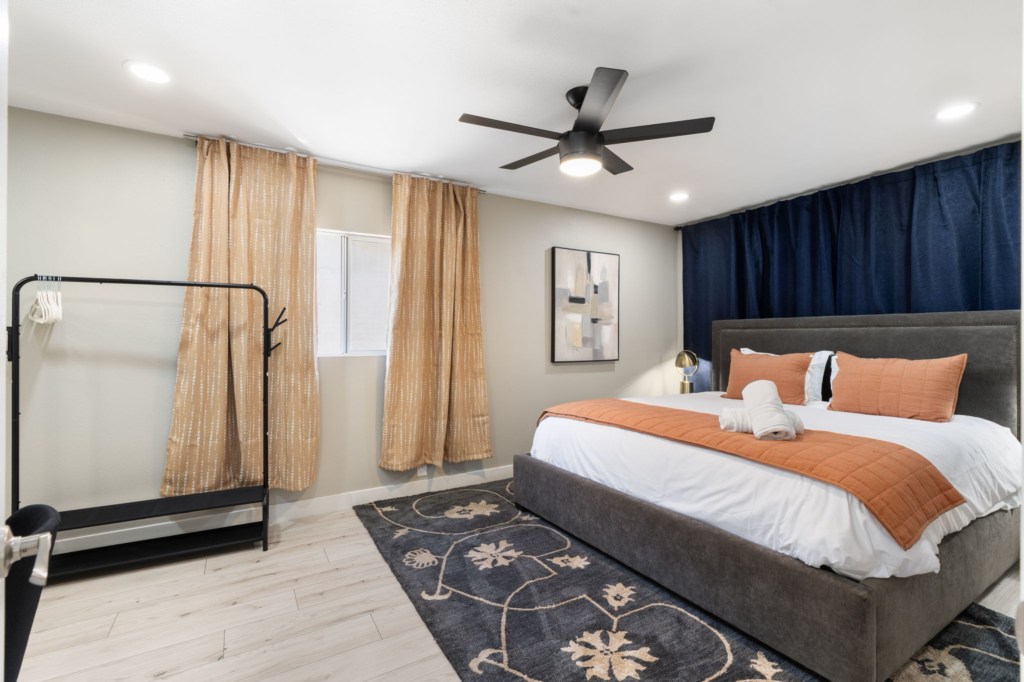 Modern bedroom with king-size bed and soft lighting for a restful night's sleep.