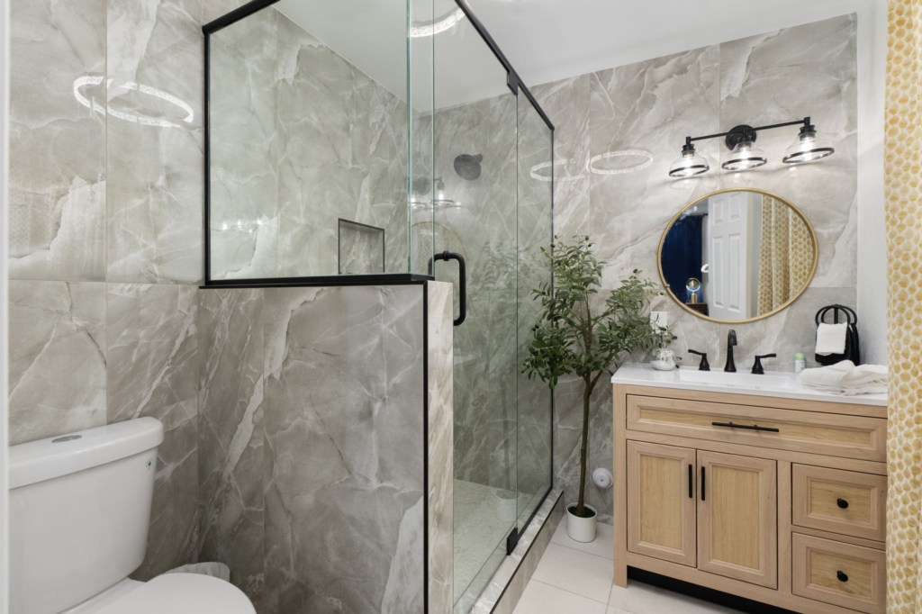Modern bathroom with glass shower and stylish vanity for a refreshing experience.