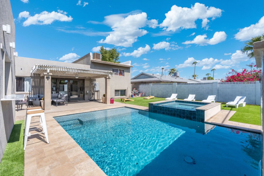 Relax by the private pool and spa with ample sun loungers and a shaded patio area.