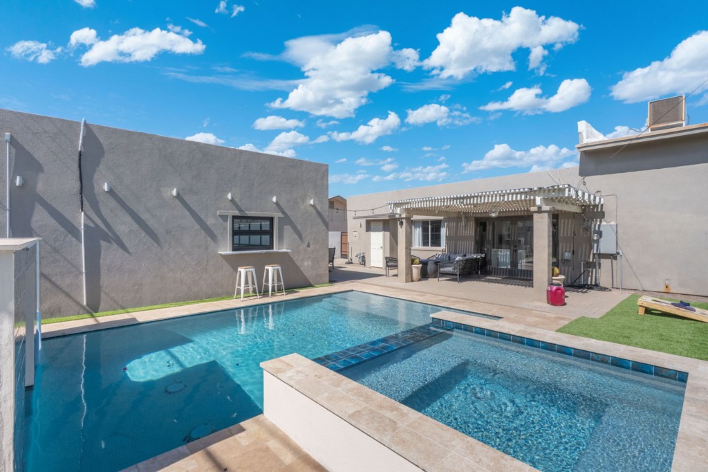 Relax by the private pool with a shaded patio, perfect for sunny afternoons.