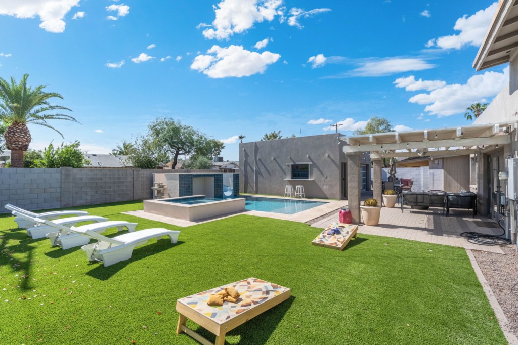 Relax by the private pool with lounge chairs and outdoor games.