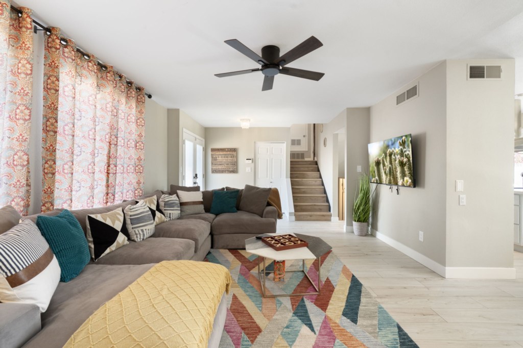 Spacious living room with cozy sectional and smart TV for relaxing evenings.