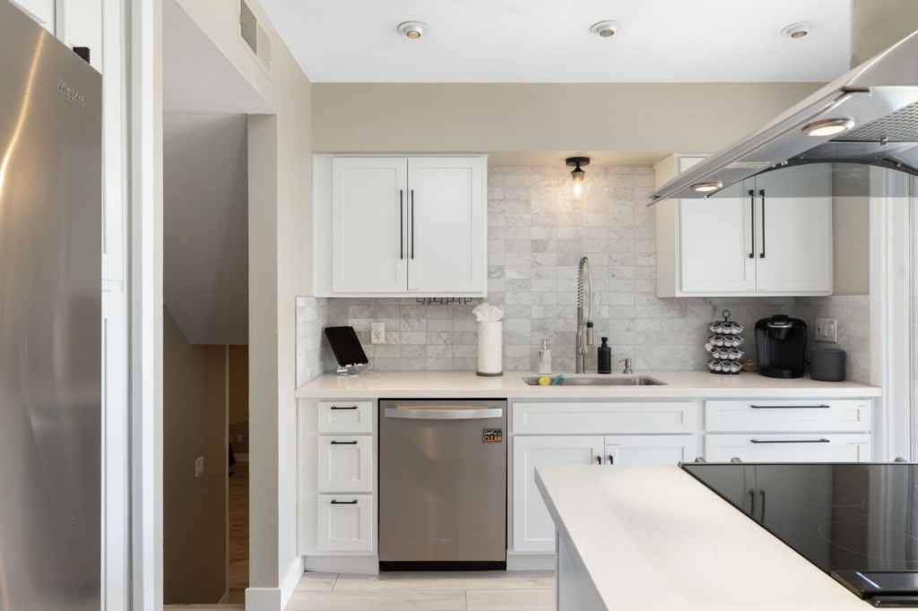 Modern kitchen with stainless steel appliances and a cozy breakfast nook.